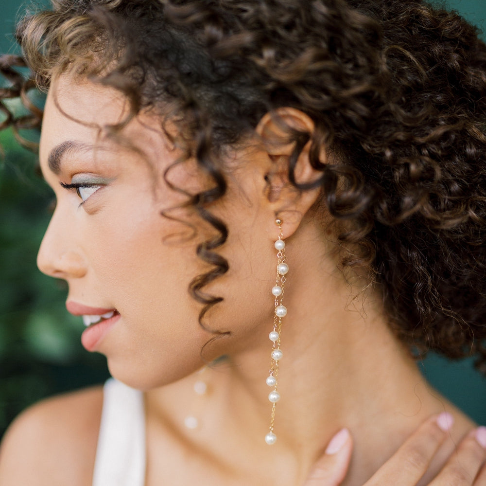 Long double strand ear hugging style earrings with 2 strands of hand linked round glass pearls in various sizes. Linked to a simple stud earrings. Available in gold filled, rose gold filled and sterling silver. handmade in toronto canada by Blair Nadeau Bridal Adornments